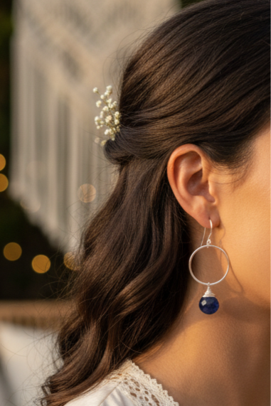 Woman wearing earrings in an outdoor setting with blurred background