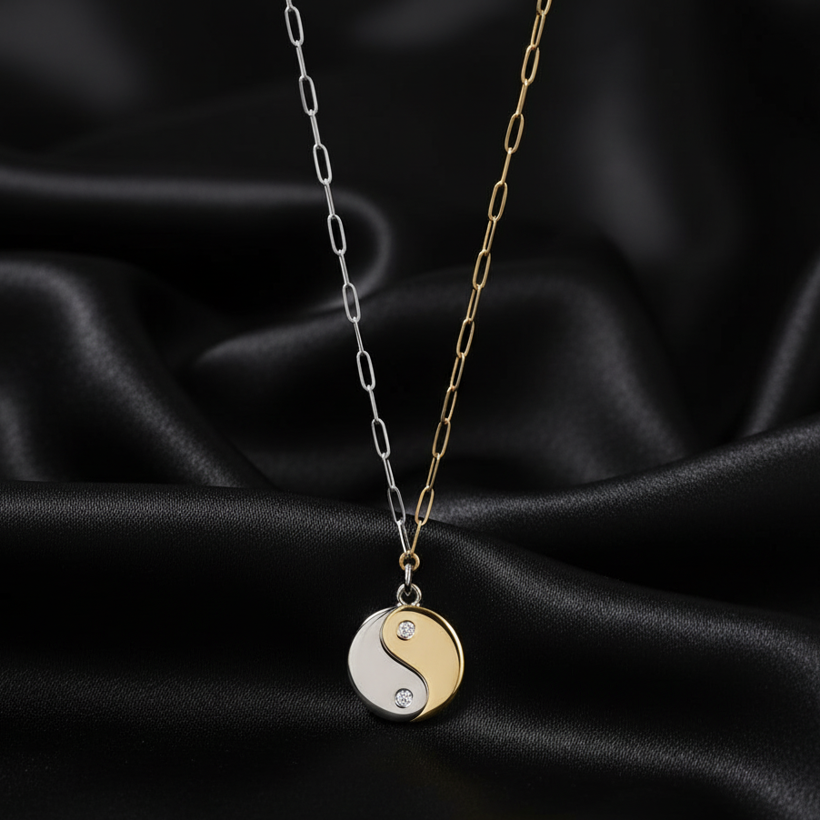 Necklace with a yin yang pendant on a black satin background