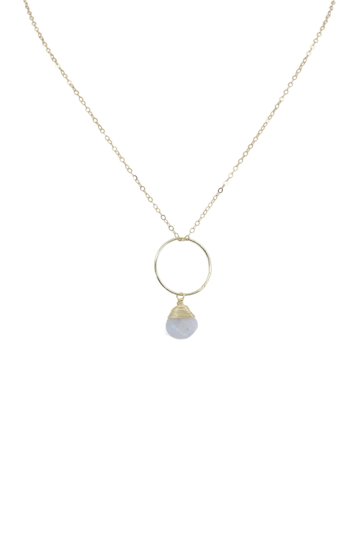 Necklace with a gold ring and gray bead pendant on a white background