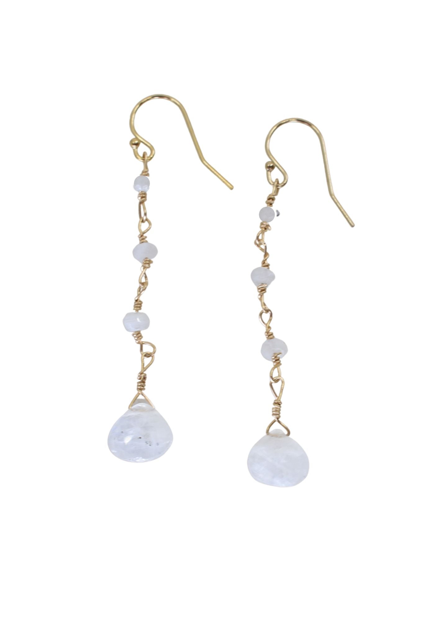 Gold and pearl drop earrings on a white background