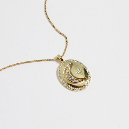 Gold necklace with a pendant on a white background